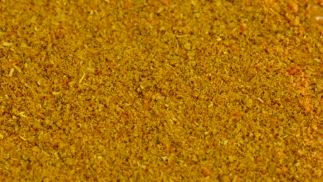 Curry-powder-falling-and-covering-white-background