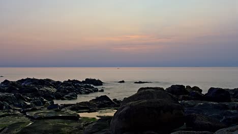 Rocky-beach-sunset-time-lapse-with-scattered-clouds