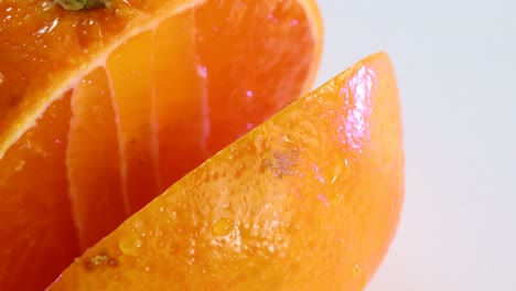 Very-sharp-knife-cutting-a-thic-slice-of-tangerine