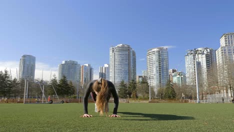 Fit-young-woman-doing-burpees-bodyweight-exercise-in-park