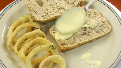 Spreading-garlic-sauce,-aioli-into-bread