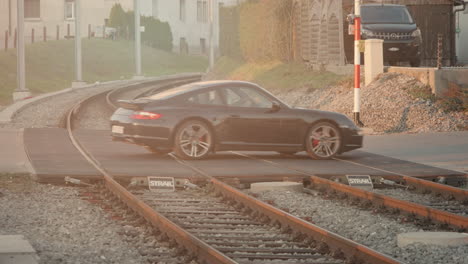 Luxury-car-crossing-railway-tracks-in-Europe