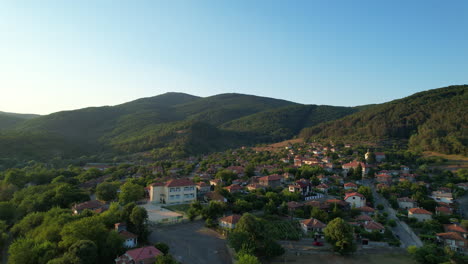 Drone-Shot-over-bulgarian-village-into-hills-and-woods-01