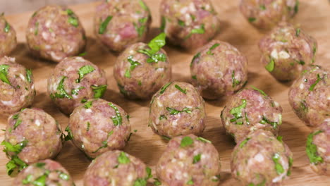 Forming-and-Preparing-Small-Pork-Meatballs-with-Fresh-Herbs,-Bunch-of-Small-Raw-Meatballs