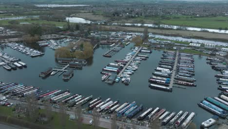 Inland-Marina,-River-Trent,-Sawley,-Nottingham,-UK,-Boat-Mooring,-Narrowboats,-Leisure-Cruisers,-Water,-Aerial-Slow-Rise-Tilt-Down,-Dull-Day,-Travel-Transportation