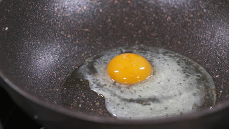 Crack-an-Egg,-Making-Fried-Egg-in-a-Black-Pan,-Fried-Eggs,-Egg-Yolk-and-Egg-White