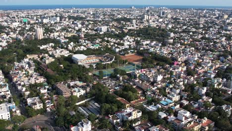 Aerial-shot-of-tennis-ground-in-the-middle-of-the-Chennai-city-India-and-the-skyline-is-blue-with-beach-view