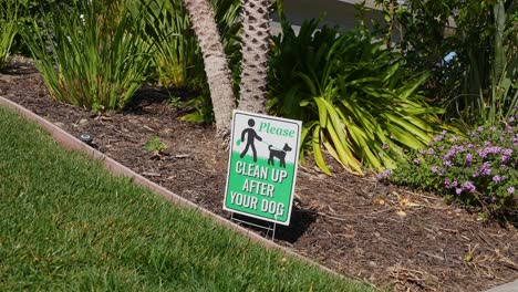 Dog-poop-sign-in-residential-lawn-and-flower-bed