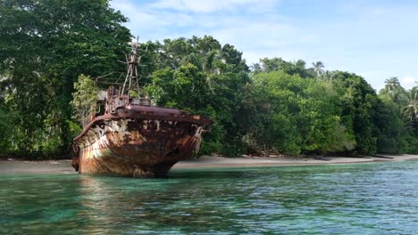 Old-rusty-shipwreck-on-once-popular-island-resort-destination-Arovo-Island,-abandoned,-in-Autonomous-Region-of-Bougainville,-Papua-New-Guinea