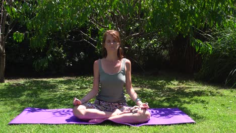 Young-caucasian-woman-breathes-and-relaxes-during-her-daily-yoga-practice