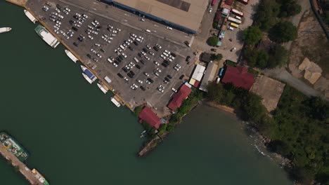 Several-ships-are-moored-at-the-quay-next-to-a-large-parking-lot-in-Sihanoukville-in-Cambodia