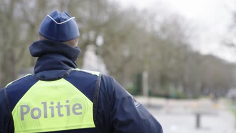 Rear-view-of-police-man-with-cap-in-Brussels,-Belgium