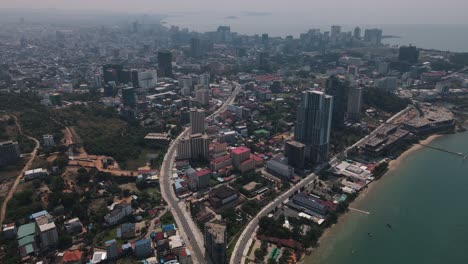 Tall-modern-hotels-and-apartments-in-the-port-city-of-Sihanoukville-between-the-less-developed-neighborhoods-of-Cambodia-with-long-winding-roads