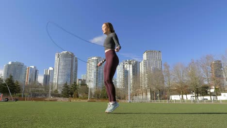 Young-woman-skipping-in-park-wide-shot-slow-motion