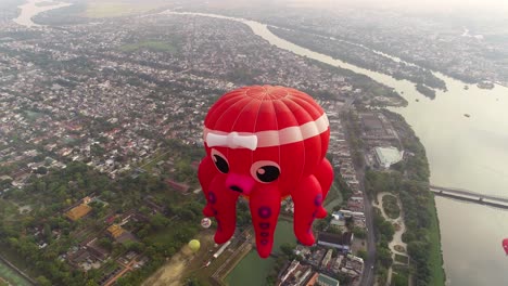 A-squid-shaped-hot-air-balloon-flies-over-the-ancient-capital-of-Hue,-Vietnam