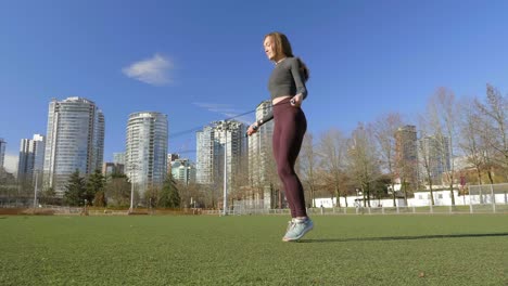 Young-woman-skipping-in-city-park-Slow-motion-wide-shot
