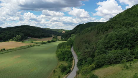 Aerial-view-of-car-driving-down-country-road-hungary