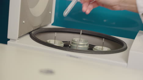 Close-Up-Of-Scientist-Putting-Test-Tube-Research-Samples-Into-Centrifuge-Equipment-In-Science-Laboratory,-4K