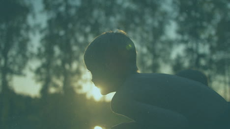 Dreamy-Vintage-film-of-Happy-1980s-childhood,-silhouette-of-boy-at-sunset