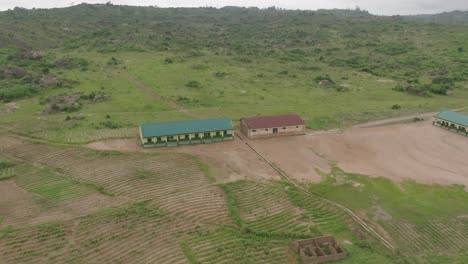AERIAL---Village-school-and-school-yard,-Jos-Plateau,-Nigeria,-spinning-shot