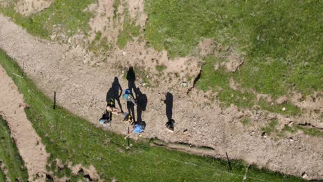 Aerial-top-down:-Group-of-hikers-meeting-on-path-enjoying-mountain-view-in-summer