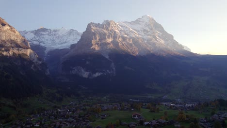 aerial-drone-footage-dolly-right-to-left-Grindelwald-village-with-unique-view-of-Eiger-North-Face-and-Fiescherhorns