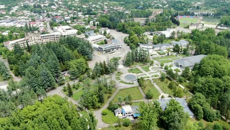 Georgia's-city-and-vibrant-green-park-with-pathways,-aerial-drone-view