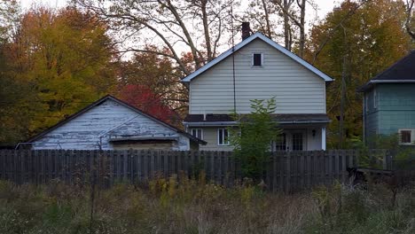Slider-Shot-Of-Old-Cottage-Design-Houses,-Trees-In-Background-In-Village
