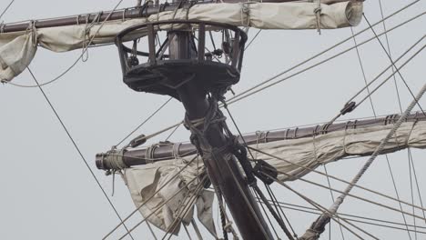 Galleon-Andalucia-replica-ship-detail-tilt-shot-of-forecastle-mast-and-sail-while-docked-in-Valencia-in-slow-motion-60fps