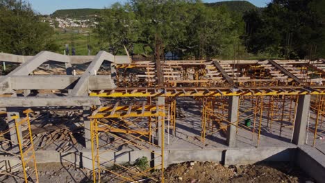 Construction-process-of-reinforced-concrete-beams-and-wooden-formwork-with-yellow-scaffolding-on-a-sunny-day