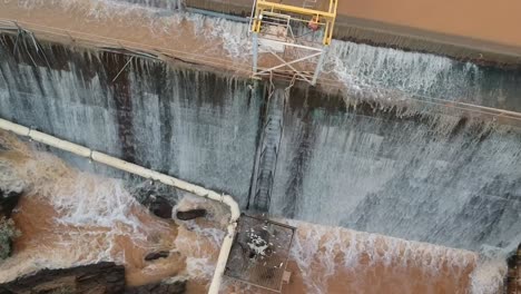 -Flood-waters-cascading-over-a-dam-wall-from-a-drone-8