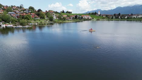 Hopfensee-lake-and-town-Hopenfen-Swabia-Bavaria-Germany-drone-aerial-view