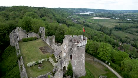 Medieval-Ruins-of-Castle-in-French-Countryside-surrounded-by-trees,-Aerial-View