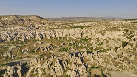 Göreme-Turkey-Aerial-v21-flyover-capturing-spectacular-landscape-view-with-unique-rock-formations,-valley,-fairy-chimneys-and-plateau-fields-in-cappadocia-region---Shot-with-Mavic-3-Cine---July-2022