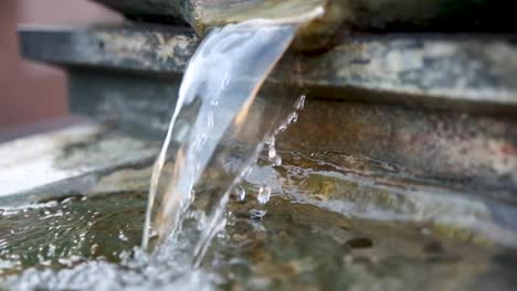 Closeup-of-water-flowing-from-a-water-fountain