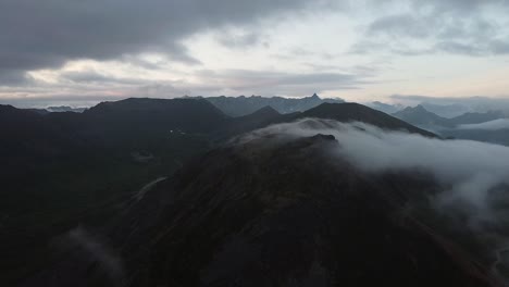 Cloud-rolling-over-Mountaintop-during-Golden-Hour-in-Alaska