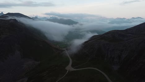 Cars-leaving-Hatcher-Pass-Clouds-Rolling-through-Valley-Alaskan-Mountain-Range-druing-the-Day