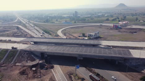 Orbiting-aerial-view-of-the-Interchange-of-Samruddhi-Mahamarg-or-Nagpur-to-Mumbai-Super-Communication-Expressway-which-is-an-under-construction-6-lane-highway