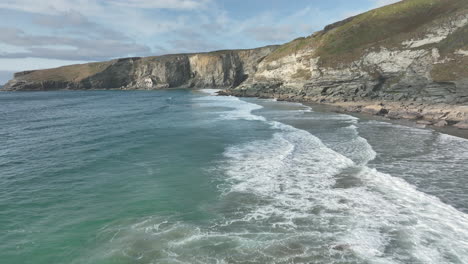 Trebarwith-beach,-Cornwall,-aerial-flight-across-beautiful-sea-to-headland-cliffs---mavic-3-cine-prores-422---Clip-4