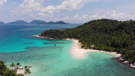 Aerial-drone-video-of-tropical-paradise-exotic-island-bay-palm-trees-with-emerald-crystal-clear-beach,-stunning-remote-pristine-reef-lagoon-with-white-sand-beach
