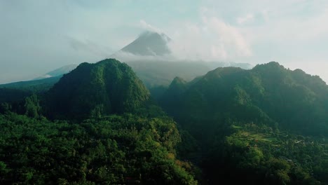 Drone-shot-of-Merapi-volcano-with-two-hills-and-overgrown-with-dense-forest