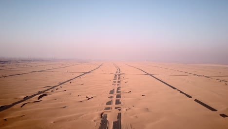 Aerial-view-of-abandoned-post-apocalyptic-roads-covered-in-sand-dunes