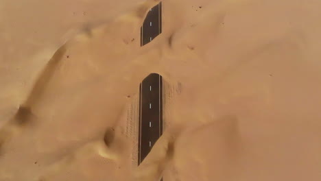 Aerial-view-of-abandoned-post-apocalyptic-roads-covered-in-sand-dunes