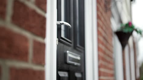 Locking-black-front-door-with-house-keys