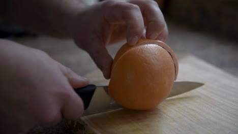 Cutting-a-Rotten-Grapefruit-on-a-Wooden-Cutting-Board