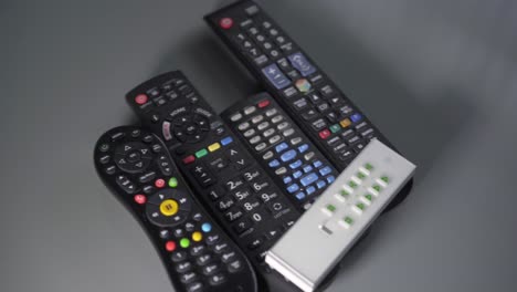 Various-remote-controls-on-a-table-pan-from-right-to-left