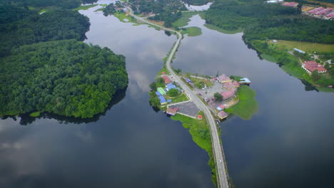Aerial-Shot-of-Lake-Raban-with-sky-reflection-and-road-on-the-lake-In-Malaysia