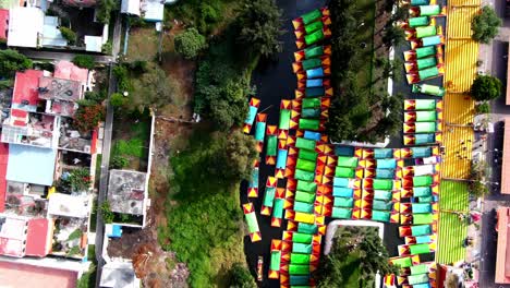 Drone-shot-of-the-floating-gardens-of-Xochimilco,-Located-in-Mexico-,-boats-in-canals,-southern-suburb-of-mexico,things-to-do-mexico-city