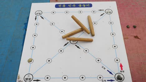 Koreanisches-Traditionelles-Brettspiel-Namens-Yut-Nori,-Auch-Bekannt-Als-Yunnori-Für-Neujahr---Asiatisches-Familienspiel