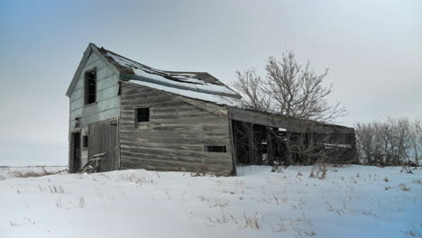Cinematic-Crane-Shot-of-Abandoned-House-in-Winter